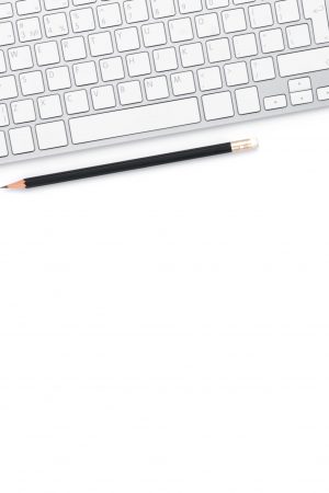Office desk table with computer, supplies and coffee cup. Isolated on white background